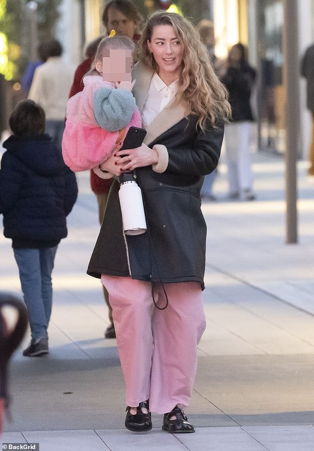 Amber Heard takes daughter Oonagh, three, for a stroll in Madrid after announcing she is expecting her second child
